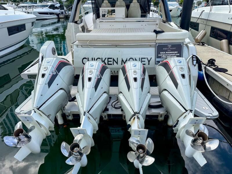 2023 Azimut Verve 47 with four powerful outboard engines docked at a marina.