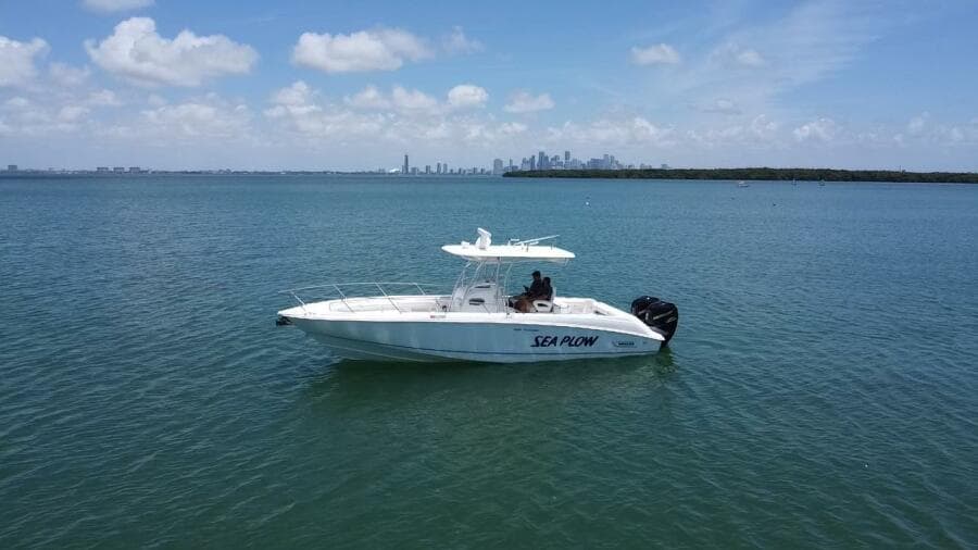 2008 Boston Whaler 320 Outrage boat named Sea Plow on calm waters.