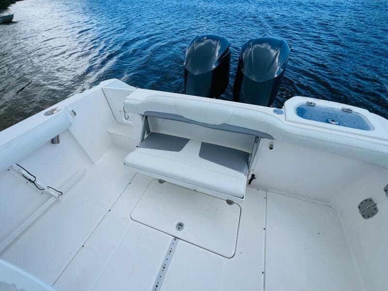 2012 Everglades 295 Center Console boat interior with dual engines on water.