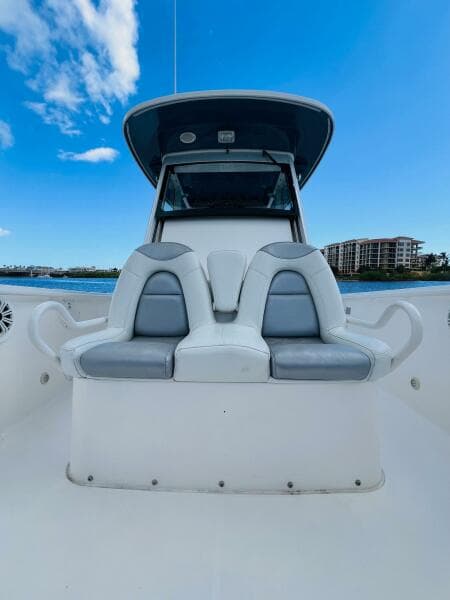 2012 Everglades 295 Center Console boat with dual seating, blue sky, and waterfront view.