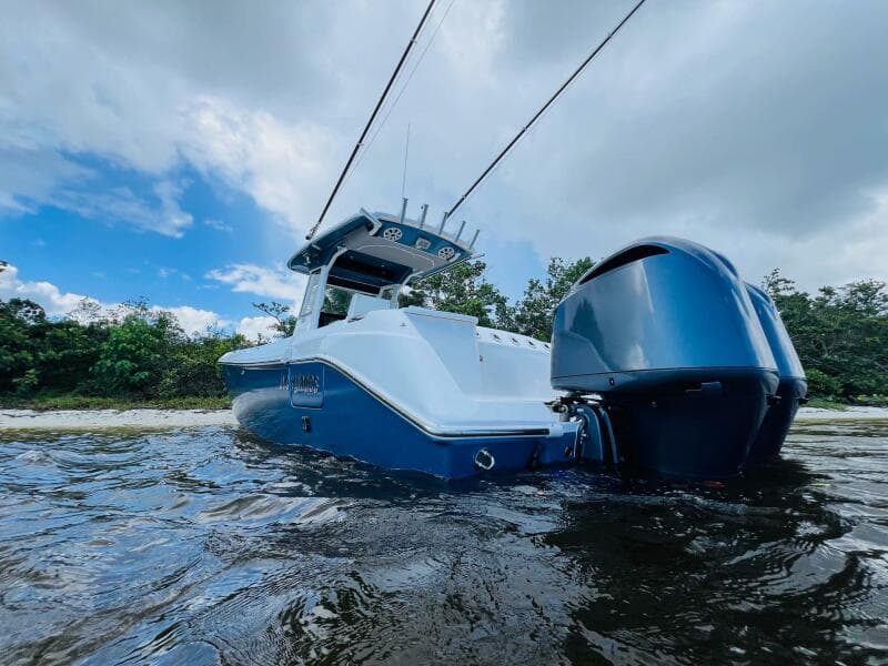 2012 Everglades 295 Center Console boat on water, under a partly cloudy sky.