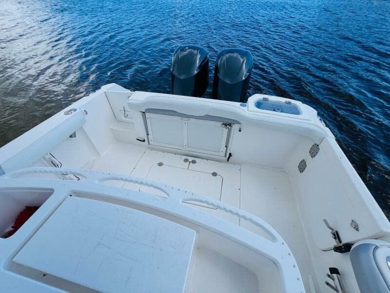 2012 Everglades 295 Center Console boat with dual engines on calm water.