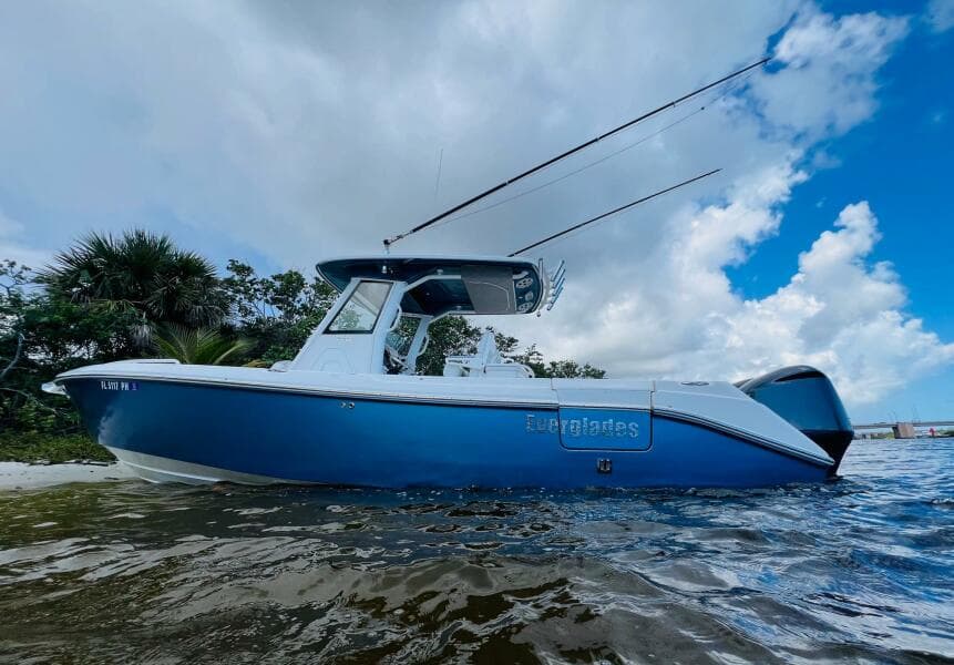 2012 Everglades 295 Center Console boat on water under cloudy sky.