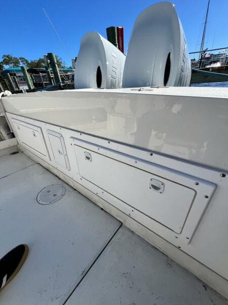 1988 Grady-White 25 SAILFISH boat deck with storage compartments and clear blue sky.