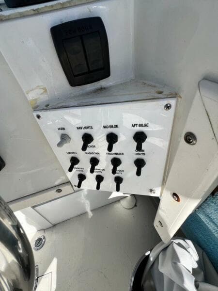 Control panel of 1988 Grady-White 25 SAILFISH boat with switches and labels.