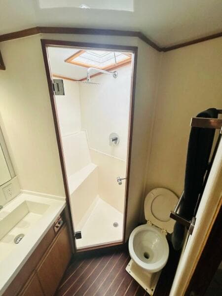 1988 Bertram 54' yacht bathroom with shower, toilet, and sink.