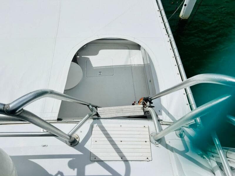 View of 1988 Bertram 54' yacht deck with metal railings and hatch.