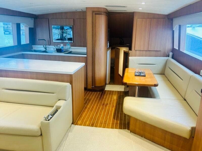 Luxurious interior of a 1988 Bertram 54' yacht with modern kitchen and seating area.
