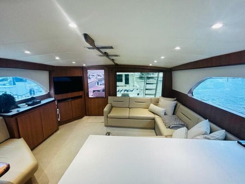 Luxurious interior of 1988 Bertram 54' yacht with modern furnishings and large windows.