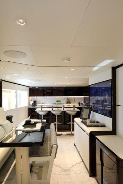 Luxurious interior of 2025 Majesty 120 yacht with modern dining and lounge area.