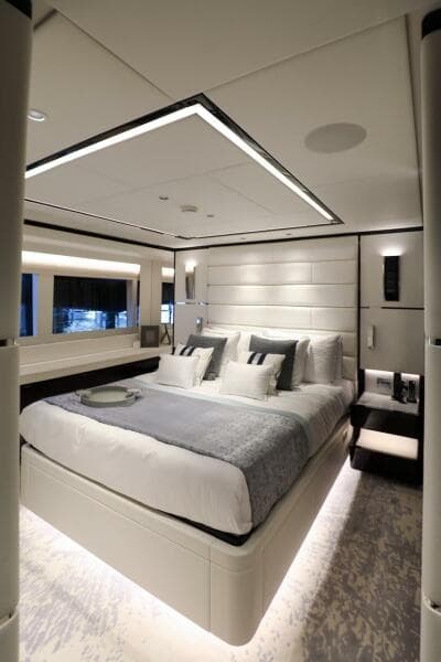 Luxurious bedroom interior on 2025 Majesty 120 yacht, featuring modern design and elegant lighting.