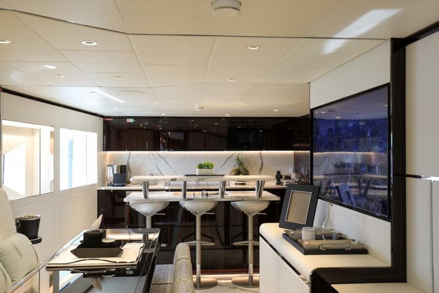 Luxurious interior of 2025 Majesty 120 yacht with modern bar and seating area.
