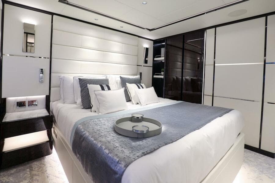Luxurious bedroom interior on 2025 Majesty 120 yacht, featuring elegant bedding and modern design.