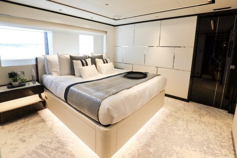 Luxurious bedroom interior on 2025 Majesty 120 yacht, featuring modern design and elegant furnishings.