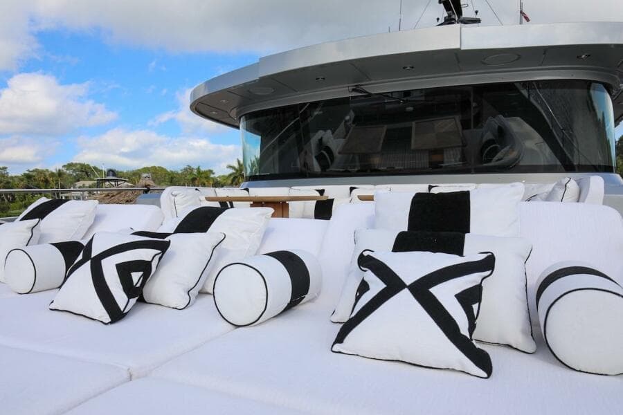 Luxurious 2025 Majesty 120 yacht with stylish black and white cushions on deck.