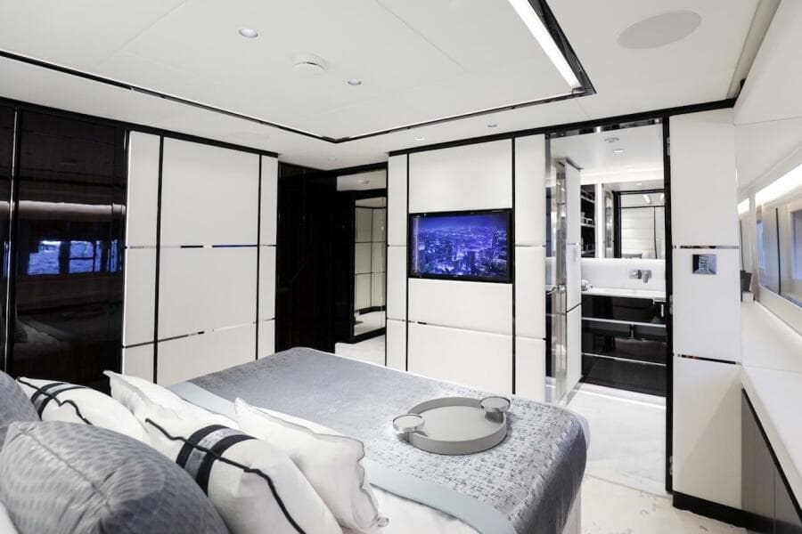 Luxurious interior of 2025 Majesty 120 yacht, featuring modern bedroom and ensuite bathroom.