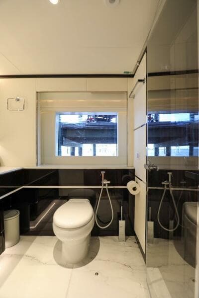 Luxurious bathroom in 2025 Majesty 120 yacht with modern fixtures and large window.