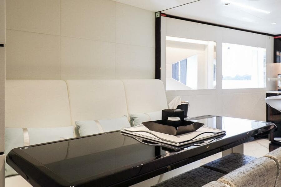 Luxurious interior of 2025 Majesty 120 yacht with sleek dining area and modern decor.