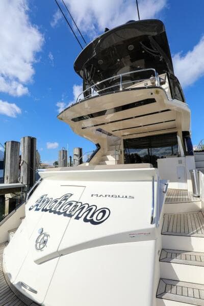 2016 Marquis 660 Sport Yacht docked under blue sky.