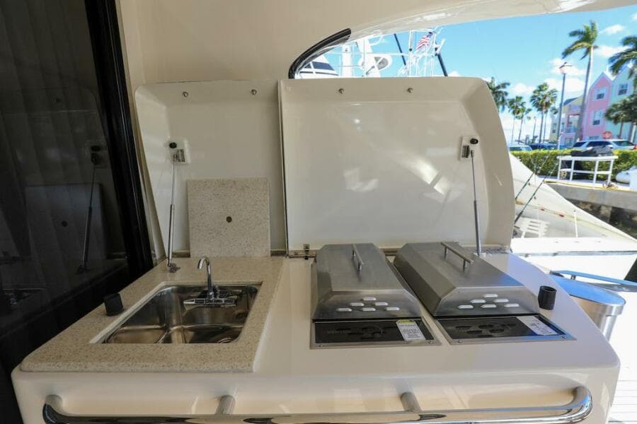 Outdoor kitchen on 2016 Marquis 660 Sport Yacht with sink and grill.