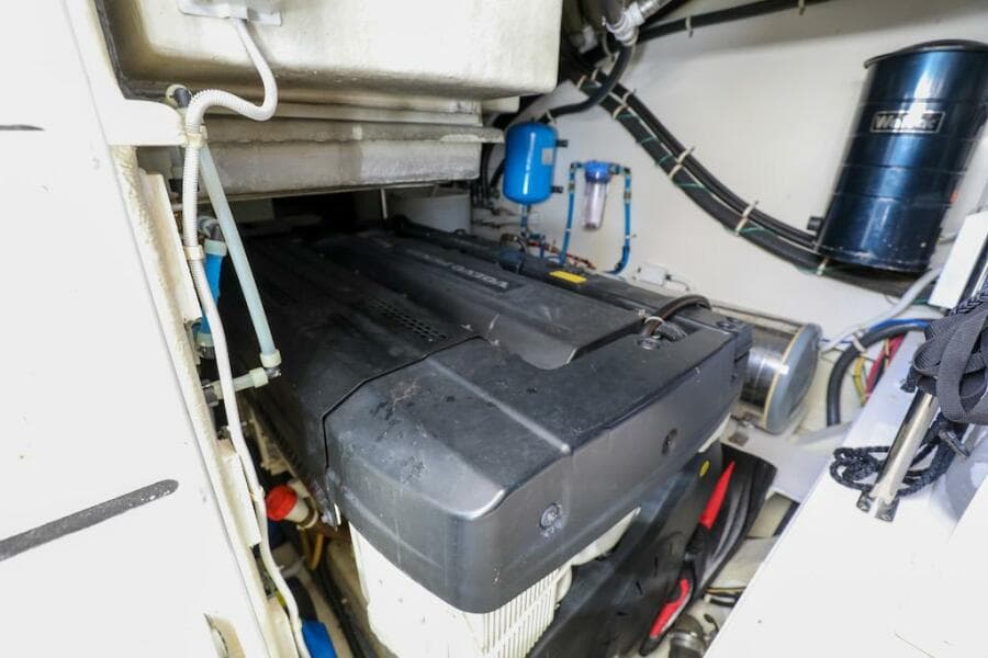 Engine room of 2016 Marquis 660 Sport Yacht, showcasing mechanical components and systems.