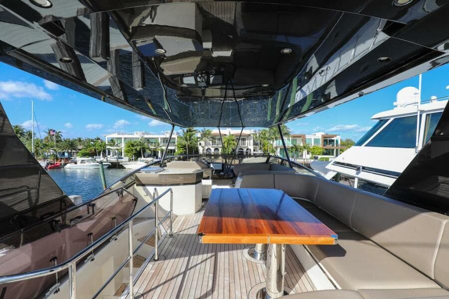 Luxurious 2016 Marquis 660 Sport Yacht with spacious deck and elegant seating area.