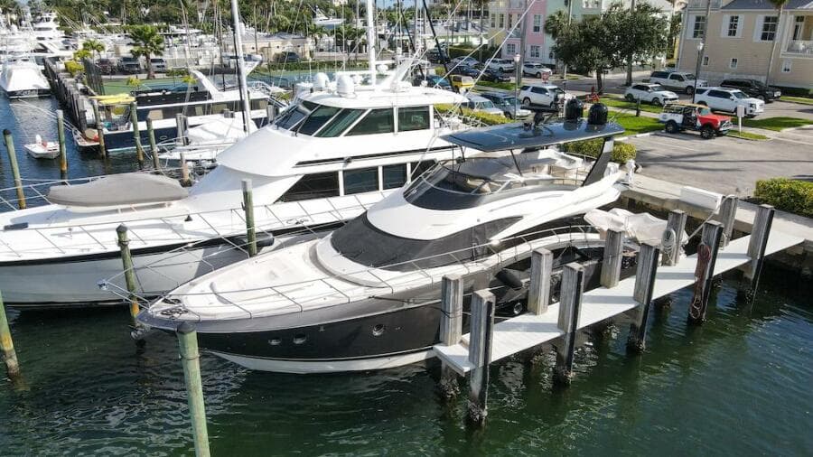 2016 Marquis 660 Sport Yacht docked at marina, aerial view.
