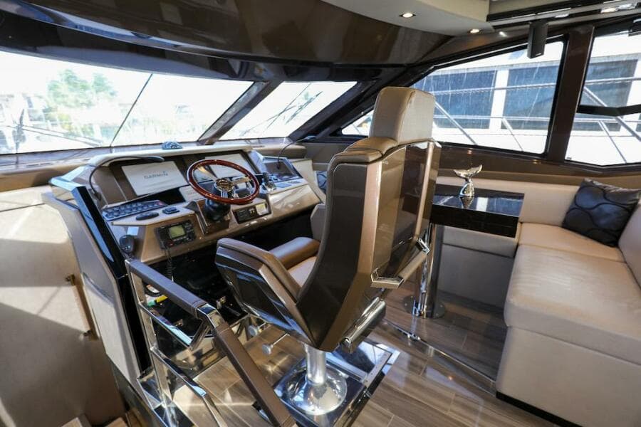 Luxurious interior of 2016 Marquis 660 Sport Yacht cockpit with modern controls and seating.