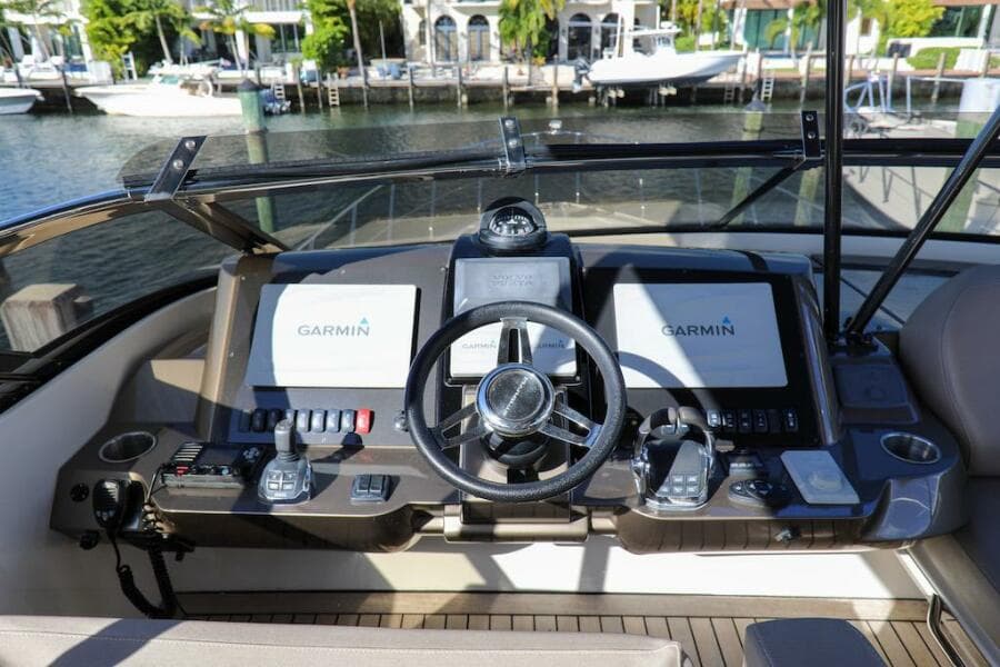 2016 Marquis 660 Sport Yacht helm with Garmin navigation displays.