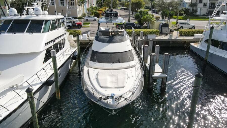 2016 Marquis 660 Sport Yacht docked at marina, aerial view.
