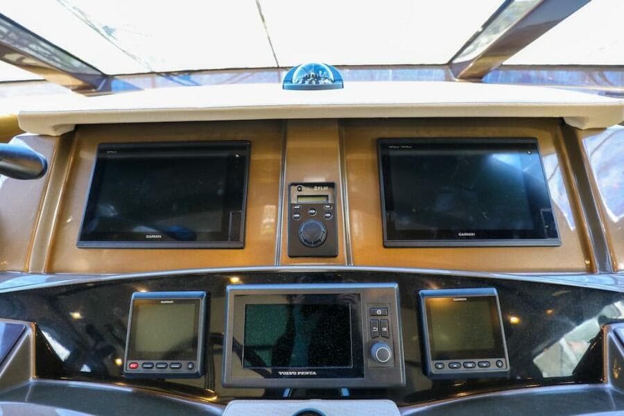Control panel of 2016 Marquis 660 Sport Yacht with multiple screens and navigation equipment.