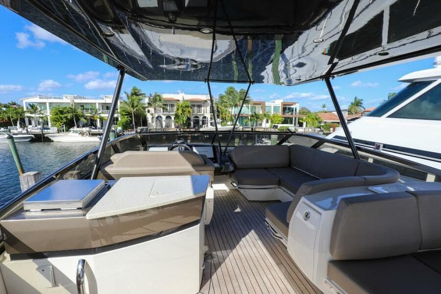 Luxurious 2016 Marquis 660 Sport Yacht interior with elegant seating and waterfront view.