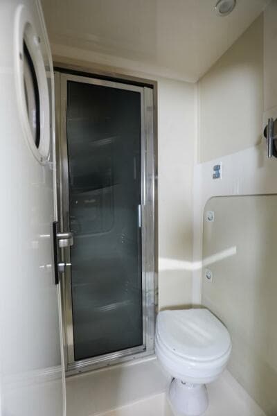 Bathroom interior of 2016 Marquis 660 Sport Yacht with shower and toilet.