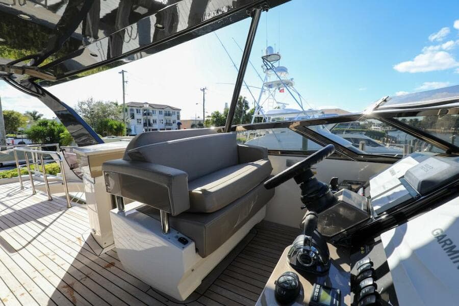 2016 Marquis 660 Sport Yacht cockpit with modern controls and seating.