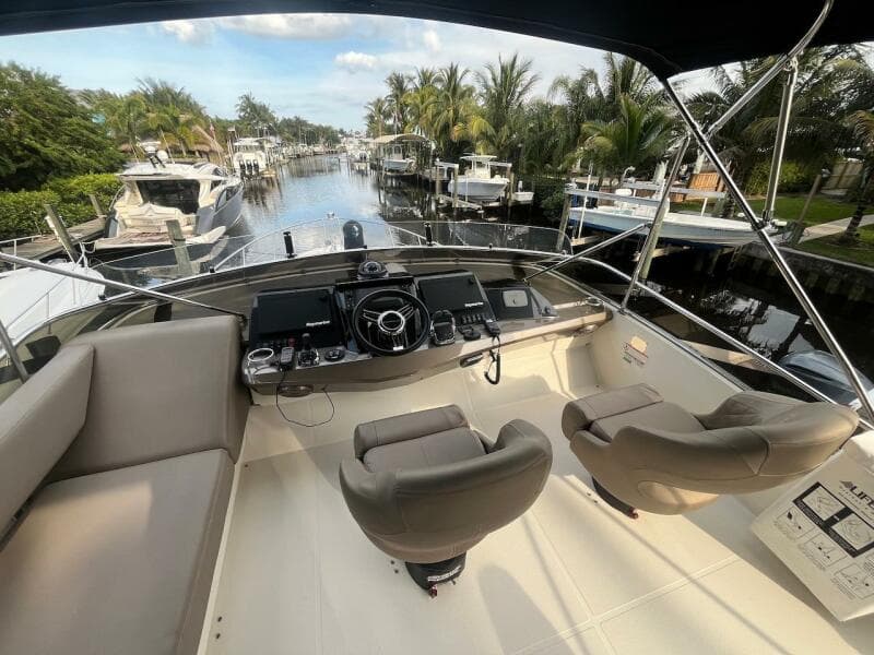 2017 Marquis 500 Sport Yacht helm station with waterfront view.