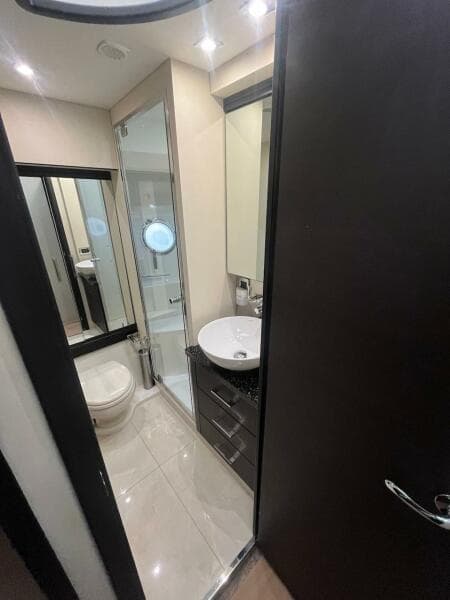 Modern bathroom in 2017 Marquis 500 Sport Yacht with sleek fixtures and ample lighting.