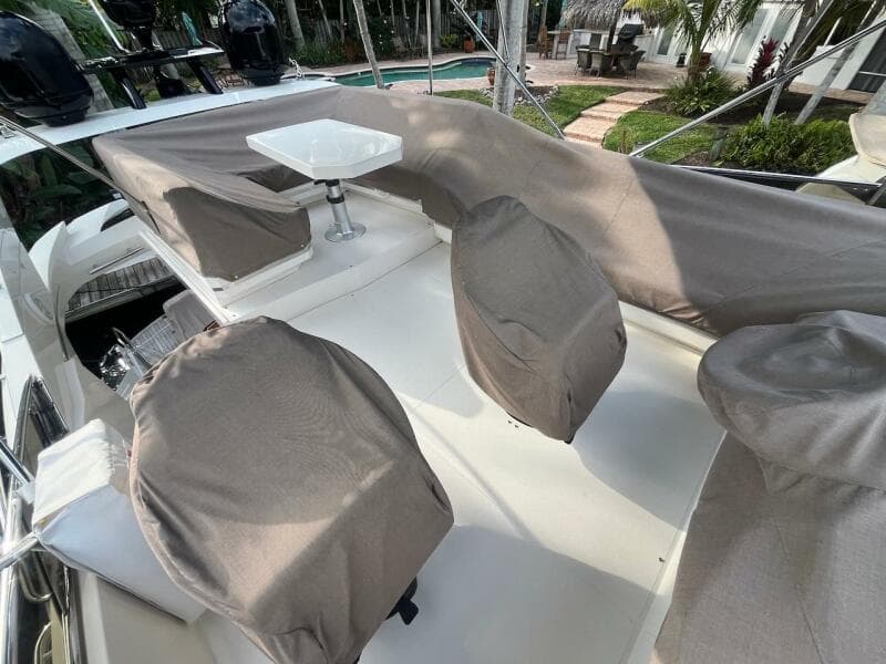 2017 Marquis 500 Sport Yacht deck with covered seating and table.