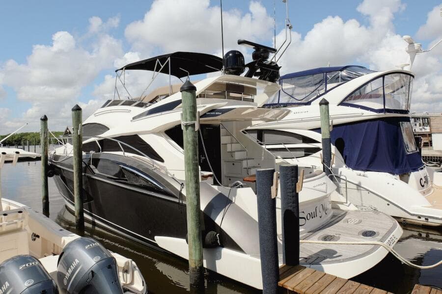 2017 Marquis 500 Sport Yacht docked at marina with other boats.