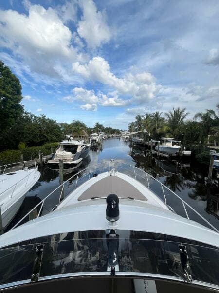 2017 Marquis 500 Sport Yacht docked in a scenic marina.