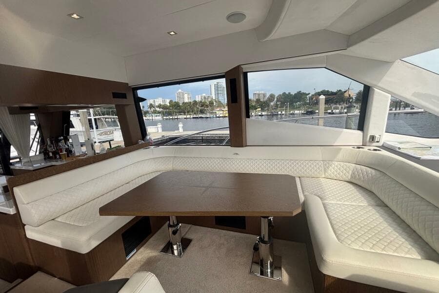 Luxurious interior of 2020 Galeon 500 Fly yacht with elegant seating and waterfront view.