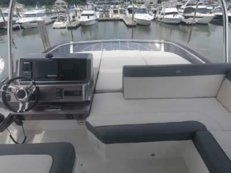 Flybridge of 2020 Galeon 500 Fly yacht with marina in background.