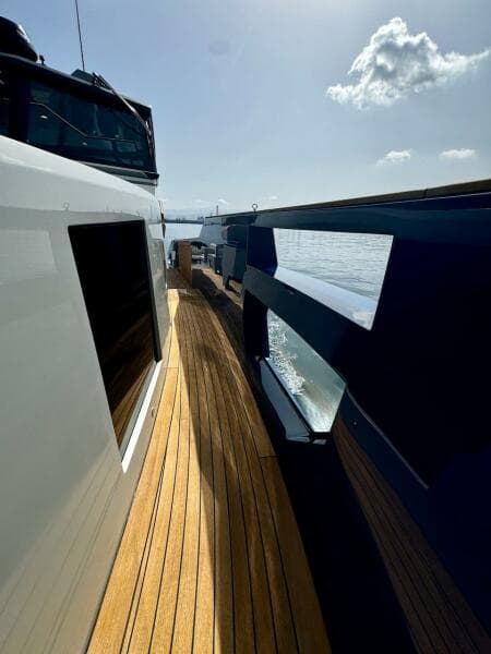 2025 Aicon Audace 50 yacht with sleek design and wooden deck, cruising on a sunny day.