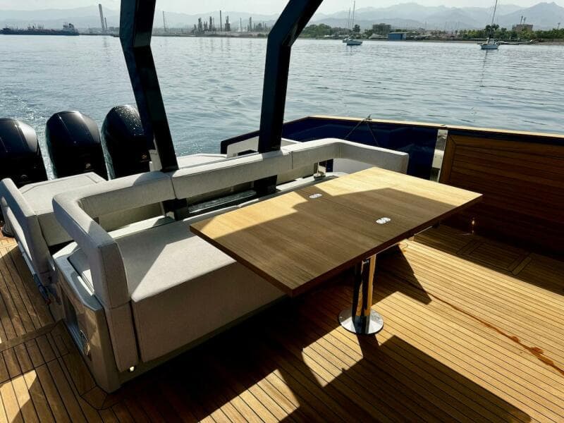 Aicon Audace 50 yacht deck with seating and table, 2025 model, on calm water.