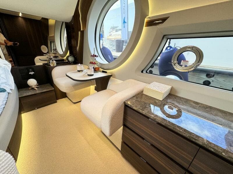 Luxurious interior of 2024 Aicon 66 Vivere yacht with elegant seating and large windows.