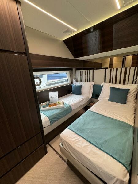Luxurious 2024 Aicon 66 Vivere yacht cabin with twin beds and elegant decor.