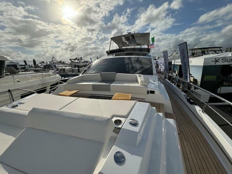 2024 Aicon 66 Vivere luxury yacht at marina under cloudy sky.