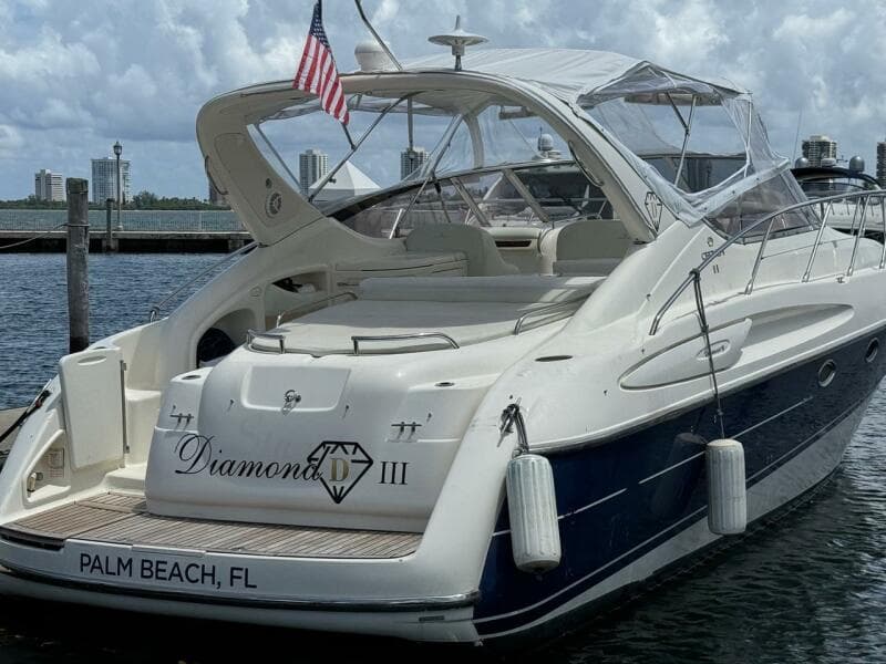 2003 Cranchi Endurance 39 yacht docked in Palm Beach, FL, with American flag.