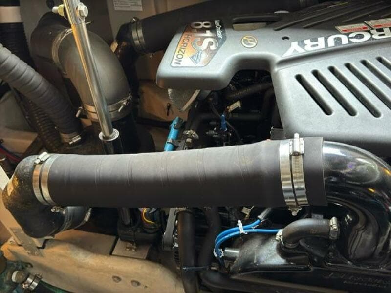 Engine compartment of a 2003 Sea Ray 380 Sundancer boat, featuring Mercury components.