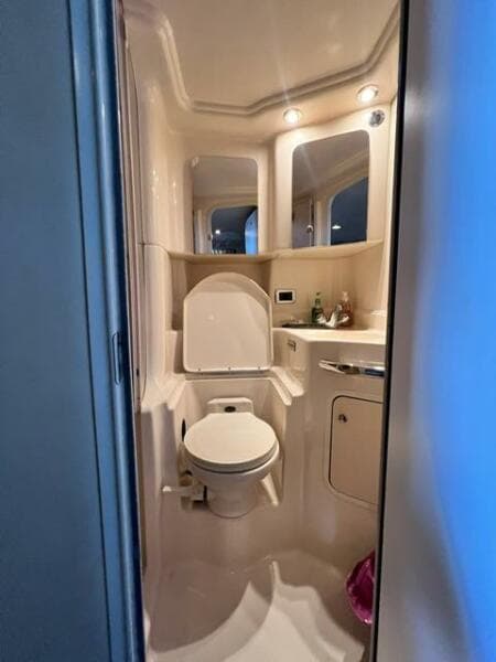 Bathroom interior of 2003 Sea Ray 380 Sundancer yacht, featuring toilet and vanity.