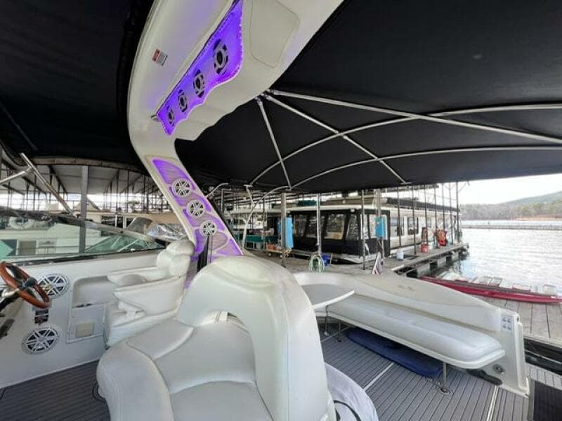 2003 Sea Ray 380 Sundancer yacht interior with seating and canopy at marina.